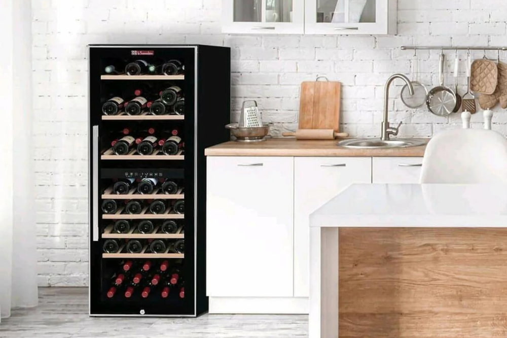 A shallow depth freestanding wine cooler at the end of a kitchen counter